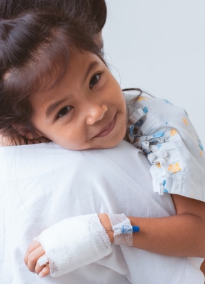 Young relaxed girl, being carried with a IV in her arm getting prepped for anesthesia.